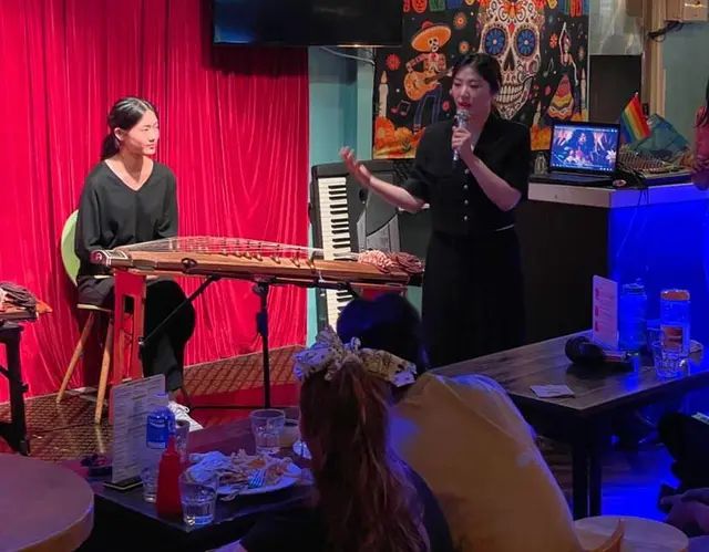 A live Open Mic performance at Taco Amigo with performers and audience tables