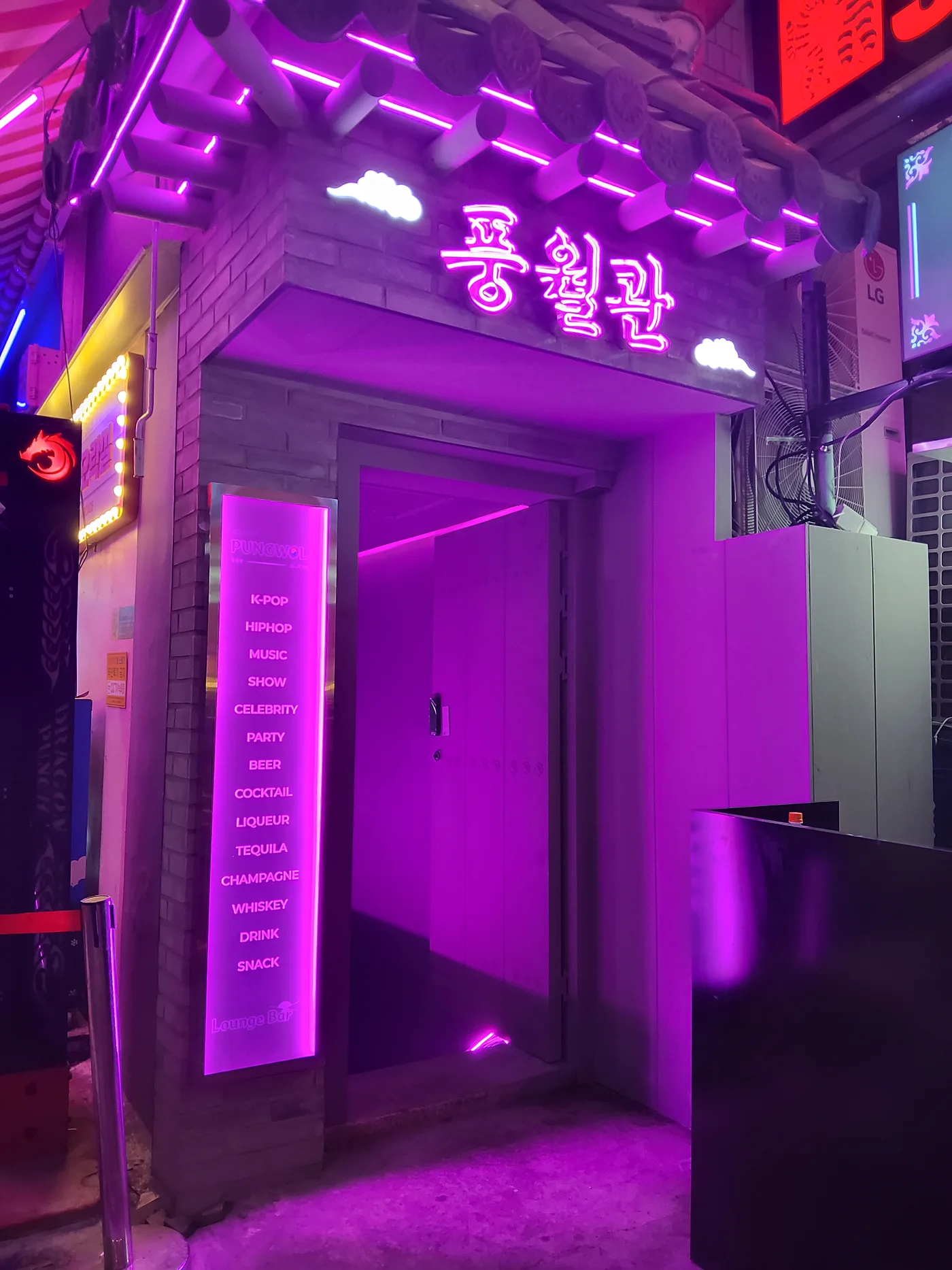 Pungwol entrance with traditional-style roof details and a pink neon sign
