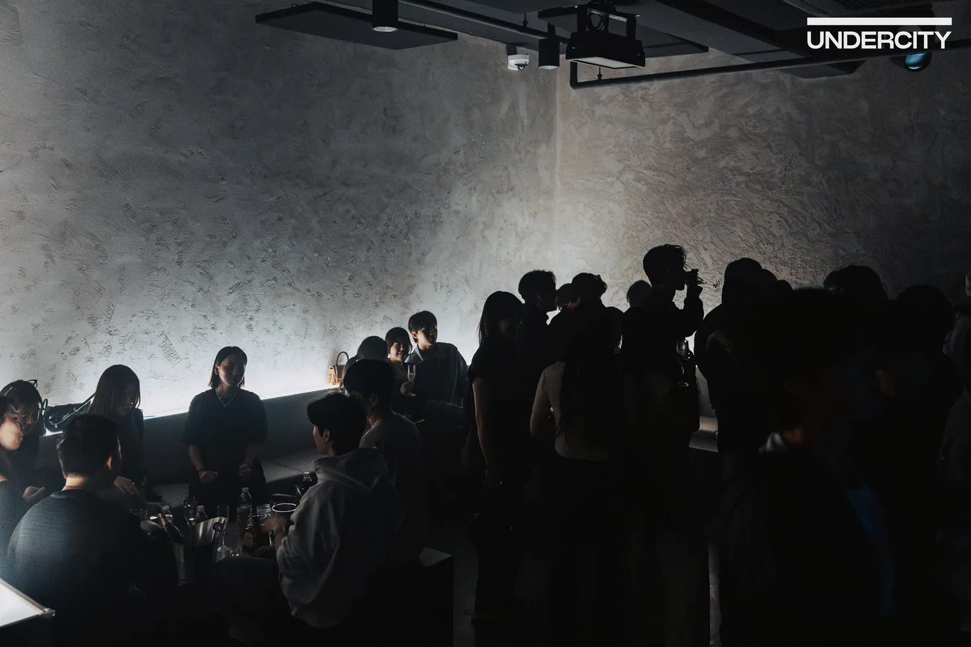 Guests gathered beside the concrete walls at UNDERCITY
