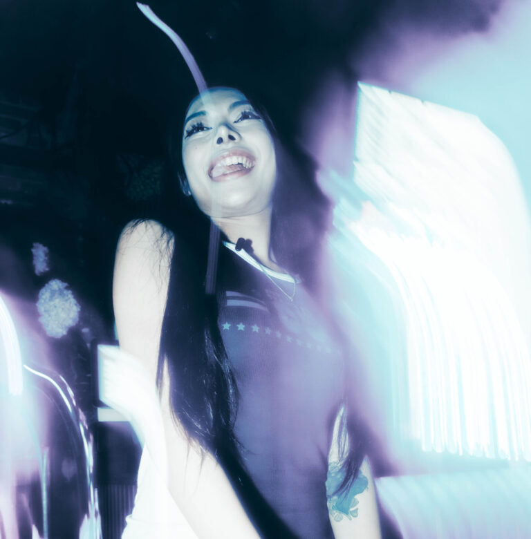 Guest dancing under colourful club lights