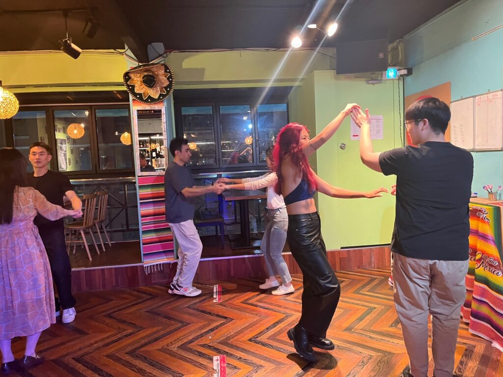 Partners practising a salsa turn at Taco Amigo in Seoul